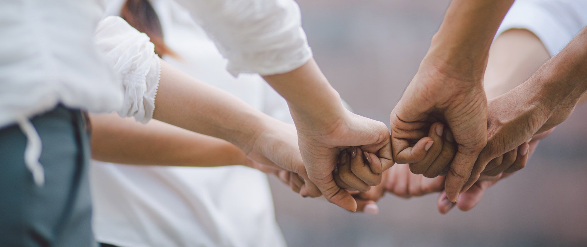 Team of colleagues with hands in center of circle