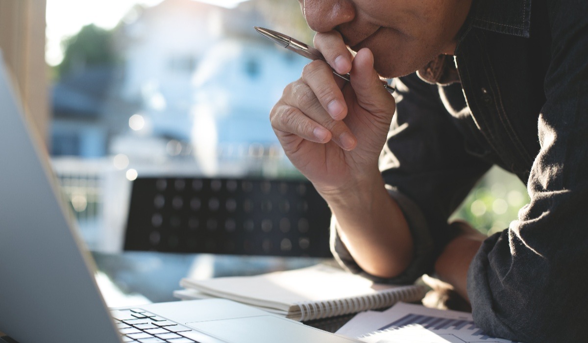 Man thinking and looking at computer